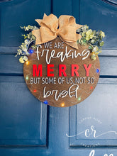 Load image into Gallery viewer, We are freaking merry but some of us, not so bright light up door sign christmas door hanger
